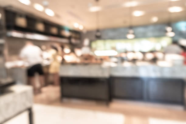 istock Buffet at hotel restaurant interior blur background with blurry open kitchen counter bar of food catering service business with chef staff cooking for breakfast, lunch or dinner meal 1391050192