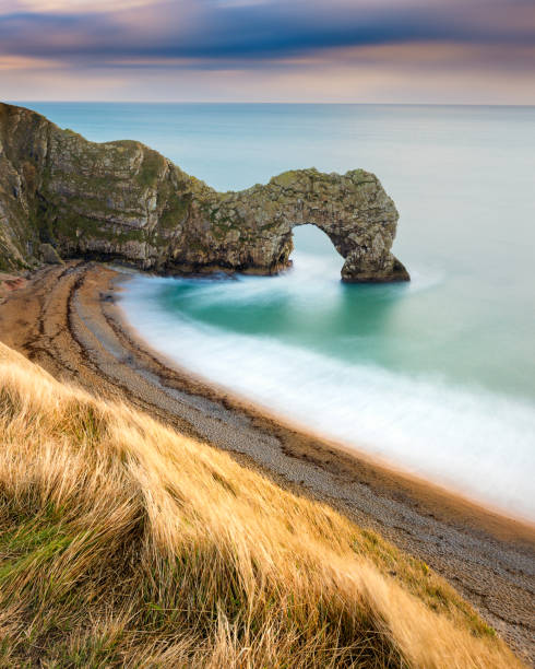 Durdle Door Landscape On The Jurassic Coast, Dorset, UK. Long exposure at Durdle Door on the Jurassic Coast in Dorset, United Kingdom. durdle door stock pictures, royalty-free photos & images