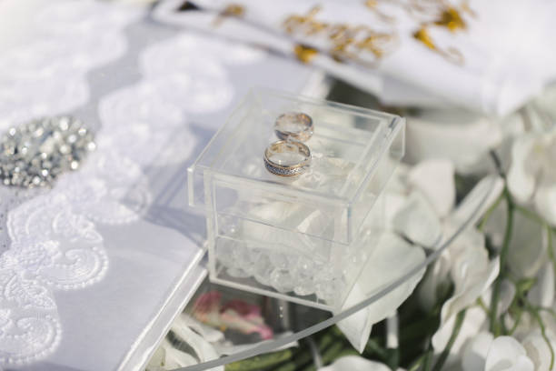 istock Two golden wedding rings in glass box. 1391050336