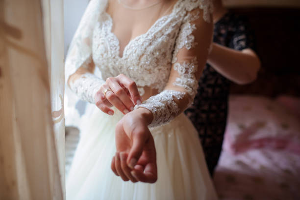 istock brides hands that arranges her dress 1391050368