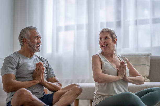istock Senior Couple Doing Yoga at Home 1391051245