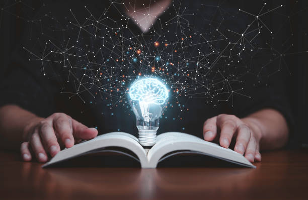 istock Glowing lightbulb with virtual brain on open book  and connection line for reading and education make smart or creative thinking idea concept. 1391051307