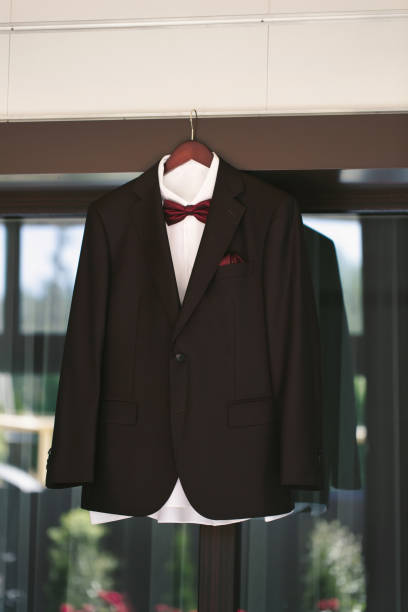 istock Suit jacket hanging on a hanger with a boutonniere in place 1391051537