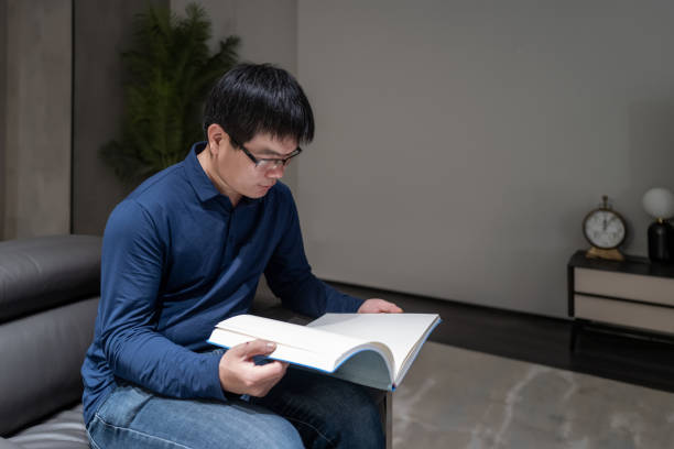istock Middle aged Asian men read on the sofa 1391057127