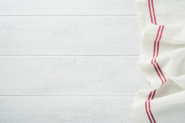 istock Linen kitchen white towel napkin on light white wooden background. Cooking stone backdrop.  Vintage zero waste silverware. Empty dishes. Top view. Mock up. 1391057701