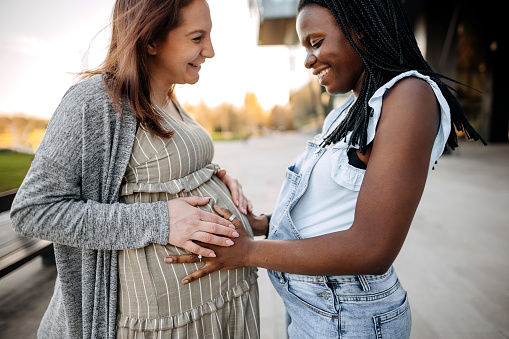 Two pregnant best friends are enjoying themselves together