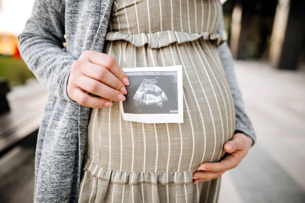 istock Pregnant showing ultrasound 1391058991