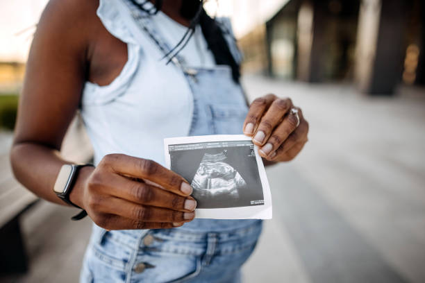 istock Pregnant showing ultrasound 1391059016