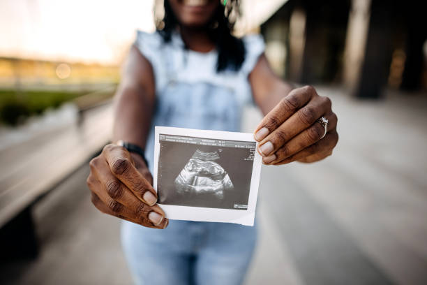 istock Pregnant showing ultrasound 1391059029