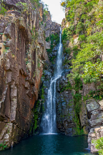 istock Beautiful waterfall called Veu da Noiva between moss covered rocks and the vegetation 1391059151