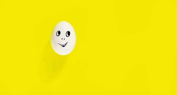 istock white egg with cheerful face on yellow background 1391059296