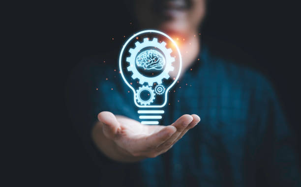istock Businessman holding virtual lightbulb with mechanical gear and brain for creative thinking idea and innovation concept. 1391059487