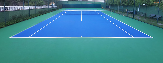 Empty tennis stadium with tennis racket and tennis balls.