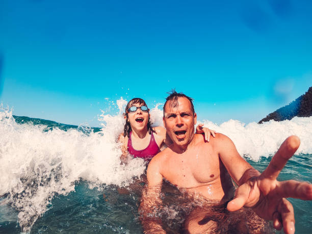 istock Father and daughter having fun on the beach 1391060721