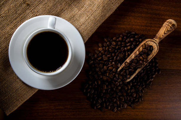 istock White cup of filter coffee with coffee beans on wooden background 1391060732