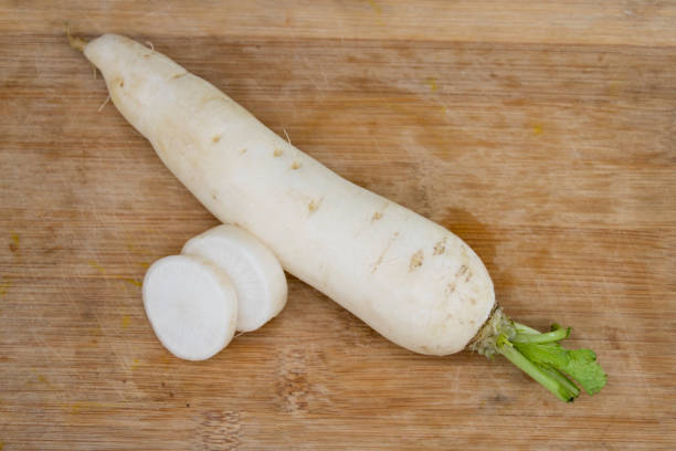 istock daikon radishes isolated on wooden background 1391062581