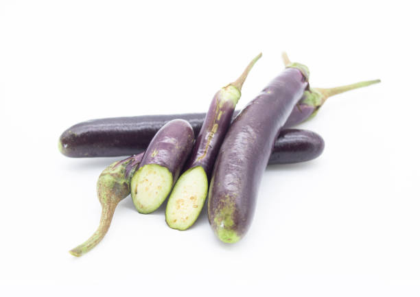 istock fresh long eggplant whole and slices isolated on white background, 1391062602