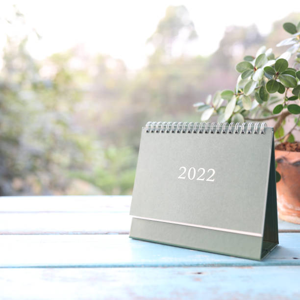 istock Green calendar on blue wooden table 1391063083