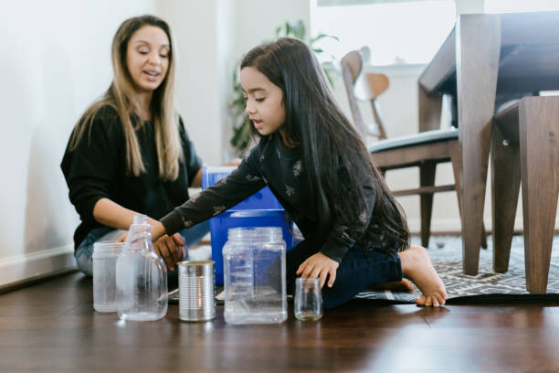istock Mother Teaching Her Daughter About Recycling 1391063479