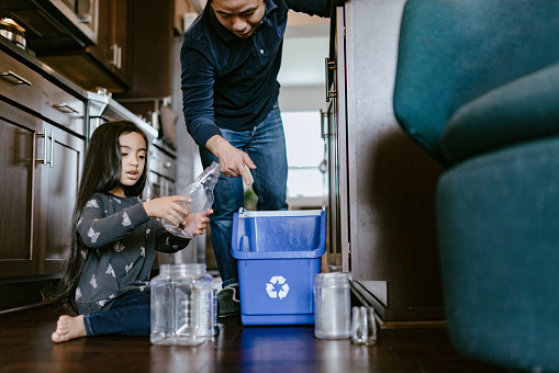 Father Teaching His Daughter About Recycling