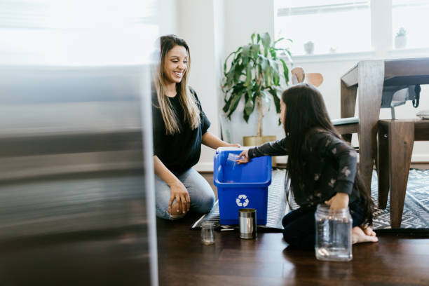 istock Mother Teaching Her Daughter About Recycling 1391063546