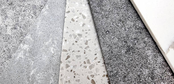 close up view of different quartz samples swatch for selection. multi color and texture of artificial stones including white marble, grey pebbles, grainy texture (focused at grained texture). - quartz imagens e fotografias de stock