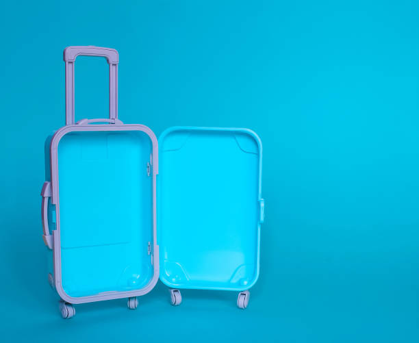 istock Fully opened blue suitcase, on a blue background, top view. Vacation, travel concept. copy space 1391063772