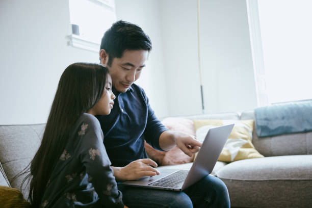 istock Father and Daughter Researching Something Online 1391063841