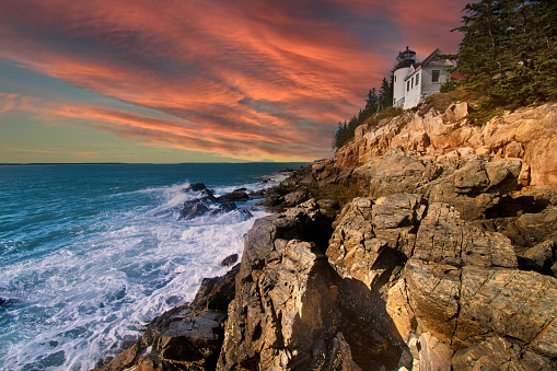 Sunset at Bass Harbor Head Lighthouse in Acadia National Park, Maine. Autumn Sunset at Low Tide.