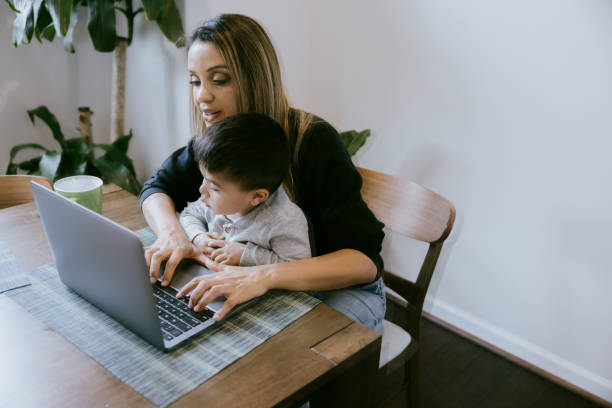 istock Mother Working At Dining Room Table With Son 1391063951
