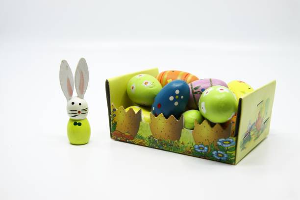 istock Cardboard basket of wooden easter eggs with Easter bunny 1391064247