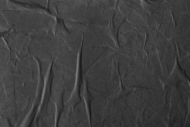 Texture of black paper with folds.