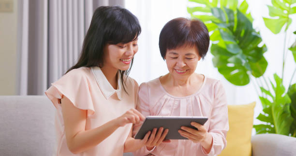 istock Daughter show tablet to mom 1391064987