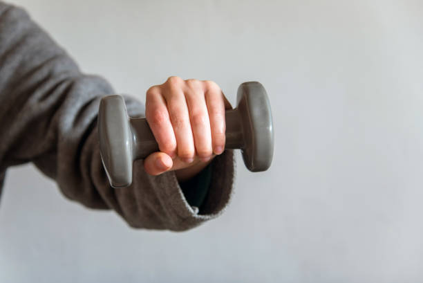 istock Woman  holding a small dumbbell 1391066307