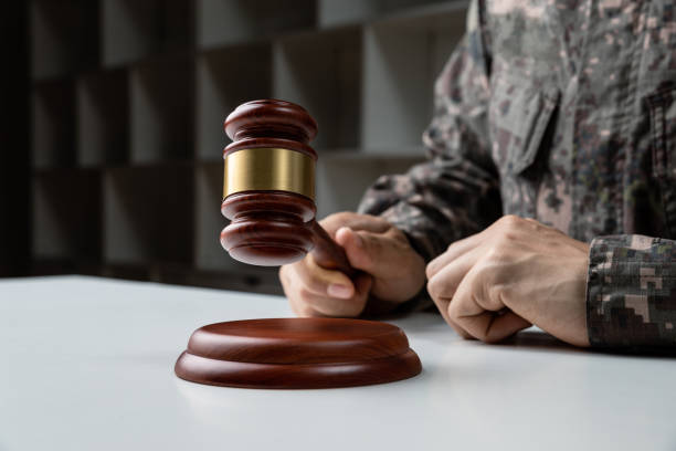 istock Hand of soldier holding gavel 1391066389