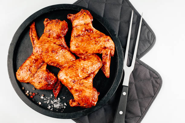istock Chicken marinated wings in red sauce with spices on a white background.Semifinished. Fast cooking.Raw marinated chicken meat.Grilled chicken wings recipe. 1391066757