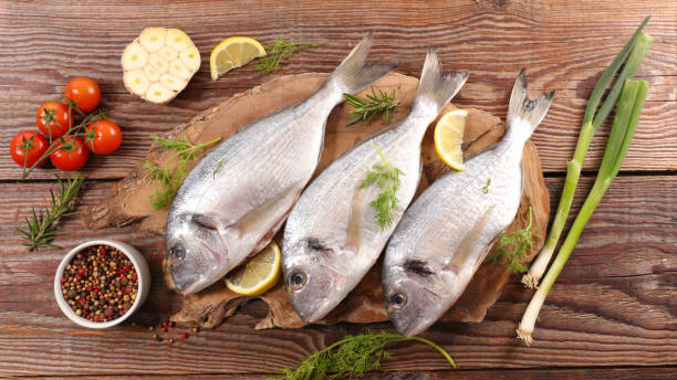 istock raw fish with peppers,  tomatoes and onion 1391067694