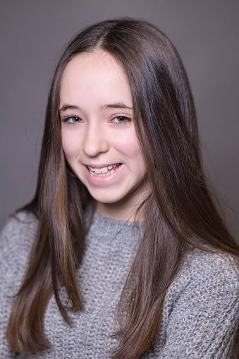 Teenaged brunette with brown eyes.