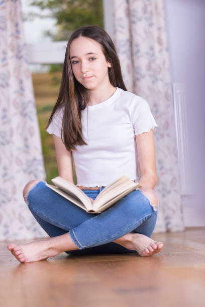 istock Reading a book on the lounge floor 1391070884