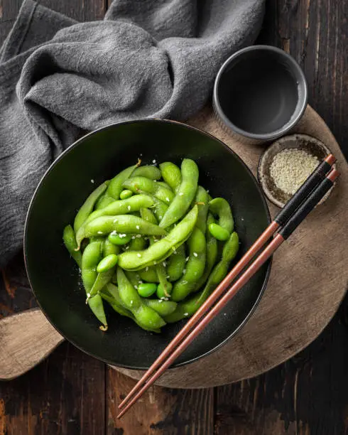 steamed edamame beans in a ceramic bowl, soybeans