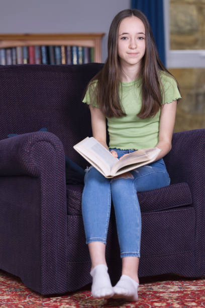 istock Teen girl reading in her study 1391071347