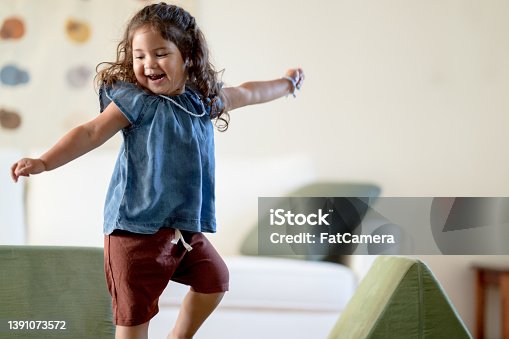 istock Little Hispanic Girl Dancing at Home 1391073572
