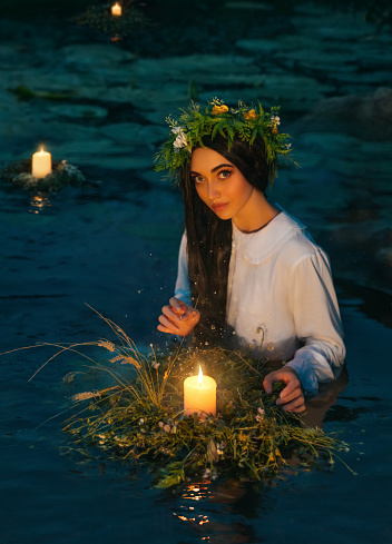 https://media.istockphoto.com/id/1391073599/photo/pagan-goddess-water-lake-ritual-flower-wreaths-float-candles-burning-girl-swims-in-riwer.jpg?b=1&s=170667a&w=0&k=20&c=x8BfdUYQg51Gr6FH516mprD5doCebv7sZZHANh_TLF4=
