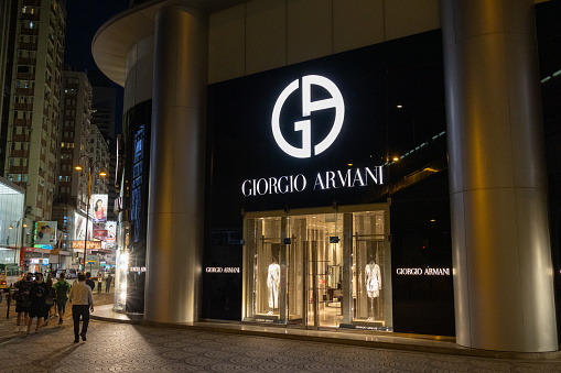 Hong Kong - April 9, 2022 : People walk past the Giorgio Armani in Canton Road, Tsim Sha Tsui, Kowloon, Hong Kong.