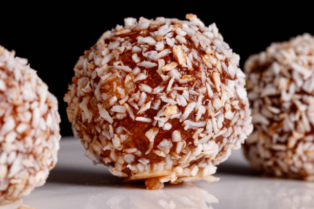 istock Beautiful sweets with coconut on a white plate on a black background 1391077178