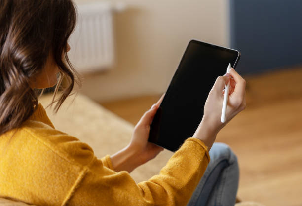 istock Girl working at home with a tablet during quarantine 1391081199
