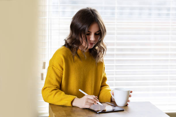 istock Girl working at home with a tablet during quarantine 1391081225
