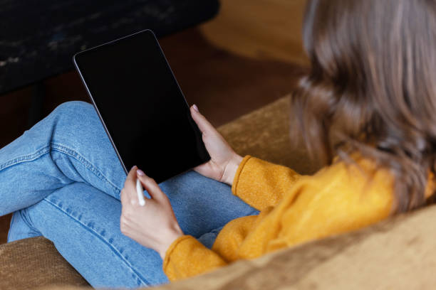 istock Girl working at home with a tablet during quarantine 1391081229