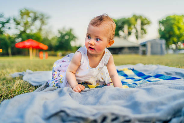 istock Baby girl on blanket at park 1391081255
