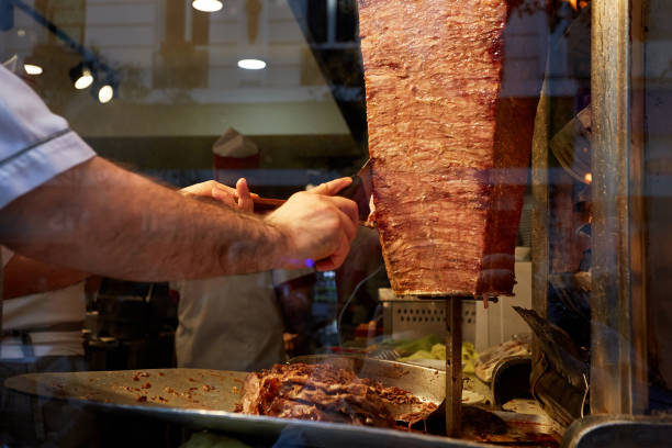 istock An arm moving to cut the kebab meat 1391081473